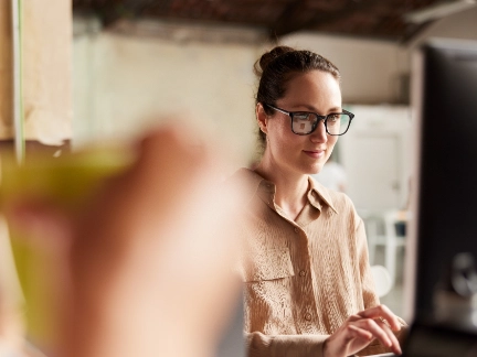 Woman wearing glasses at computer