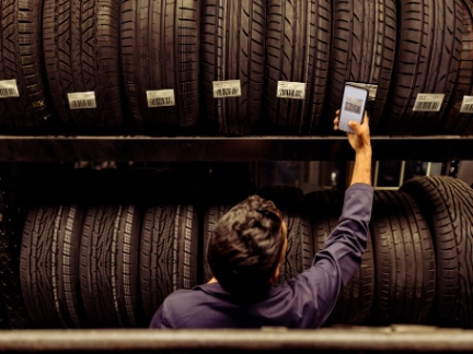 Automotive worker checking tyres