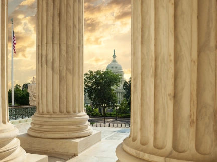 capitol building through columns of supreme court