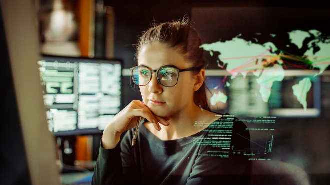 Young female IT worker looking at screen