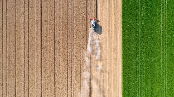 Over head view of farming tractor ploughing a field