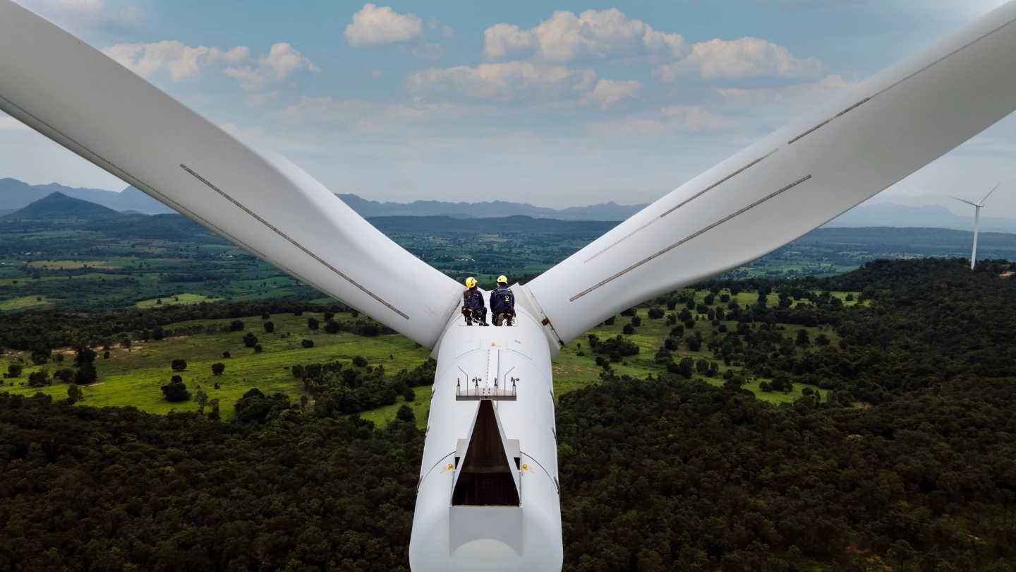 Two workers in the distance on a high level turbine image