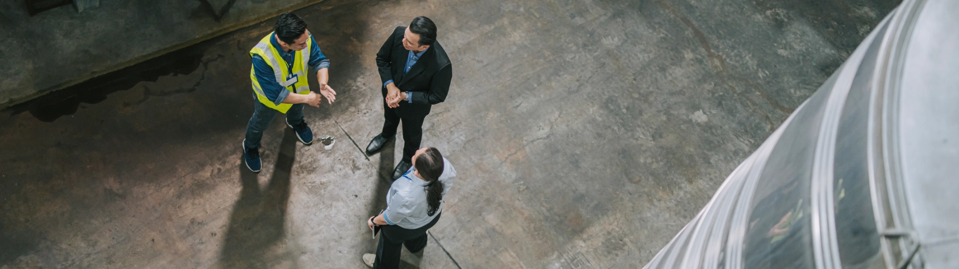 Workers having a discussion in a large warehouse