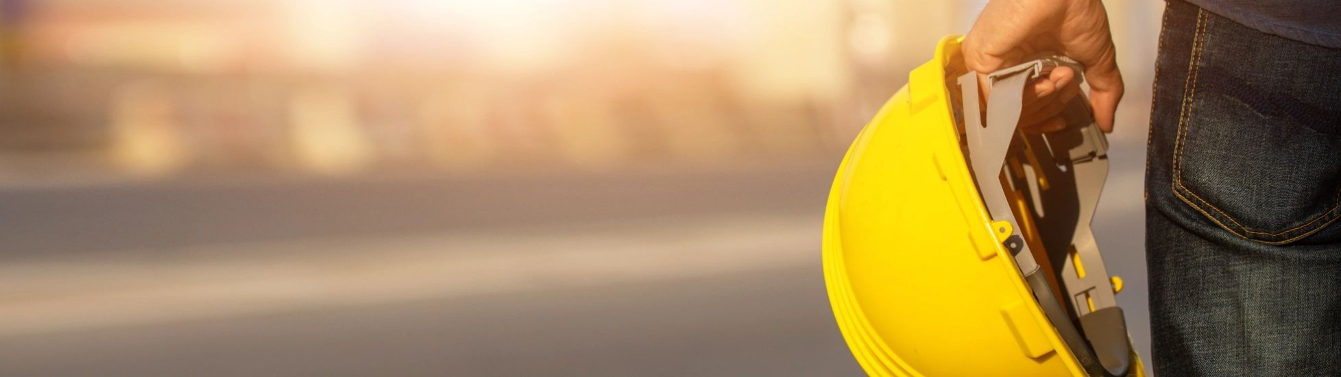 Construction worker holding safety helmet