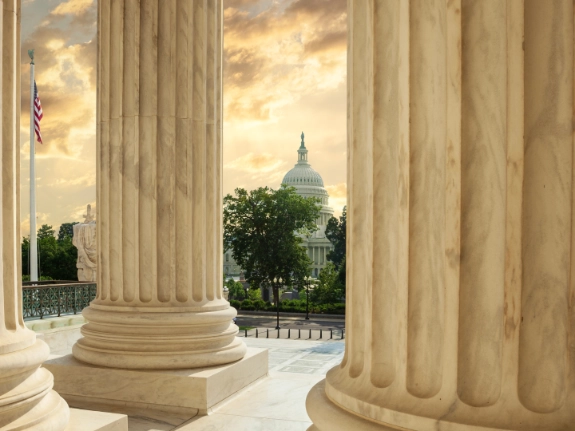 capitol building through columns of supreme court
