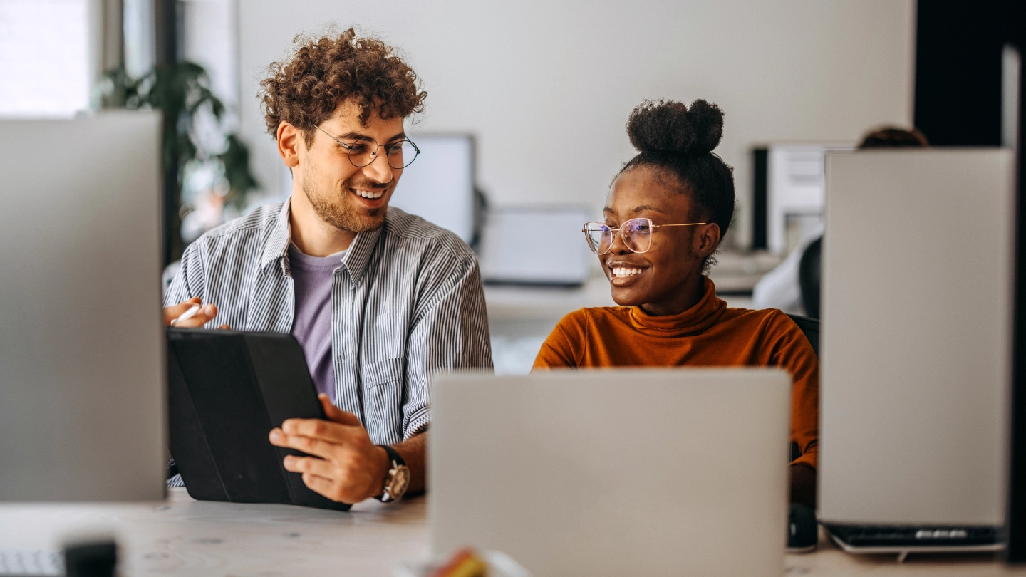 woman and man behind computers image